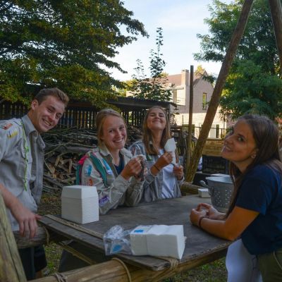 Yelena Van Sichem scouts en gidsen aan een gesjorde eettafel.