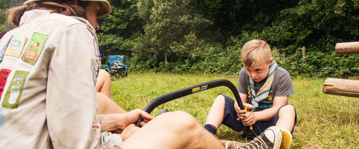 fotograaf: Hana Reynaert leider en akabeër zijn samen hout aan het zagen op kamp