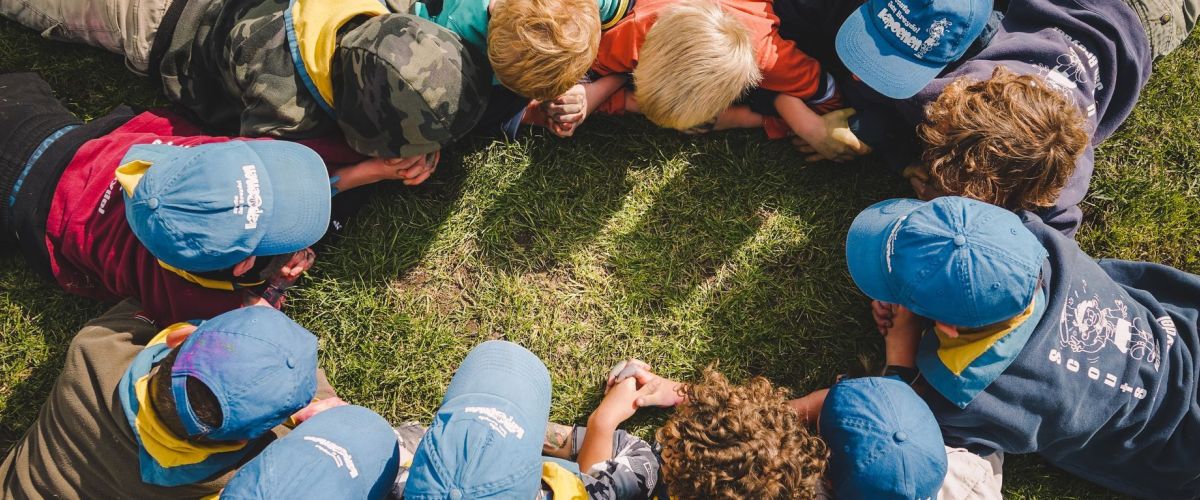 Fotograaf Groep leden liggen allemaal op hun buik in een grote kring