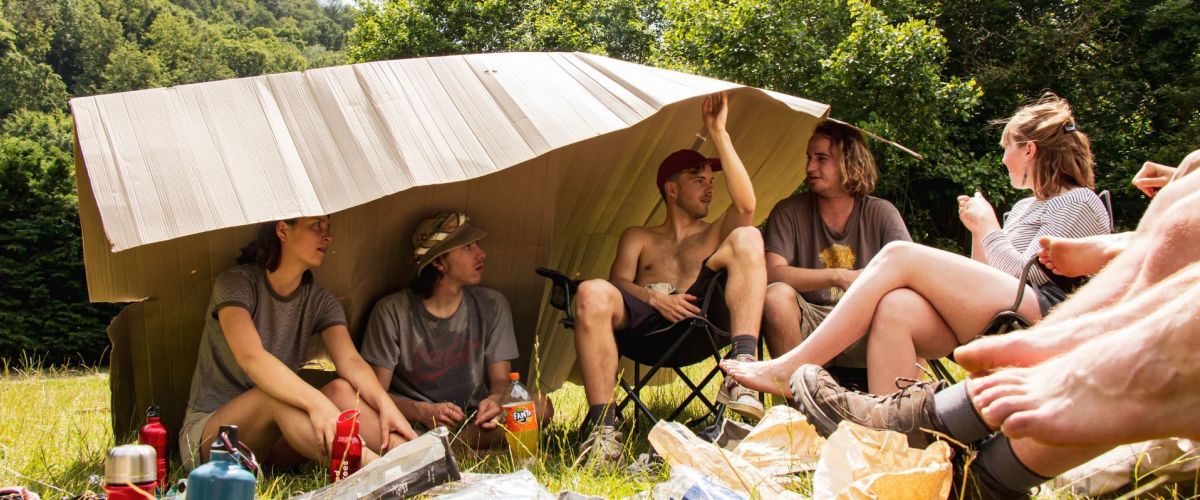 givers schuilen voor de felle zon onder een groot karton